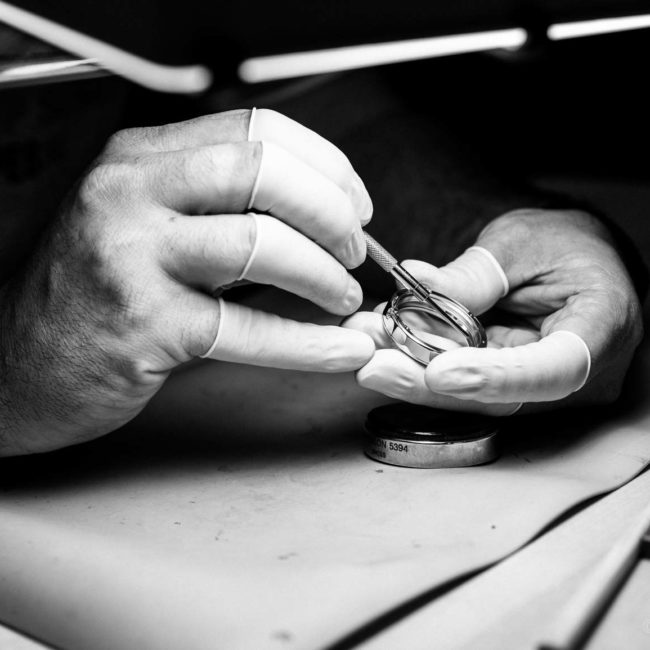 CNC technician inspecting a watch case.