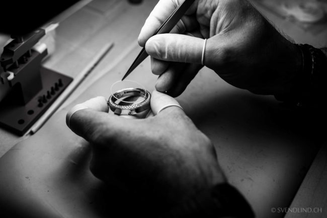 A CNC technician verifies watch case dimensions.