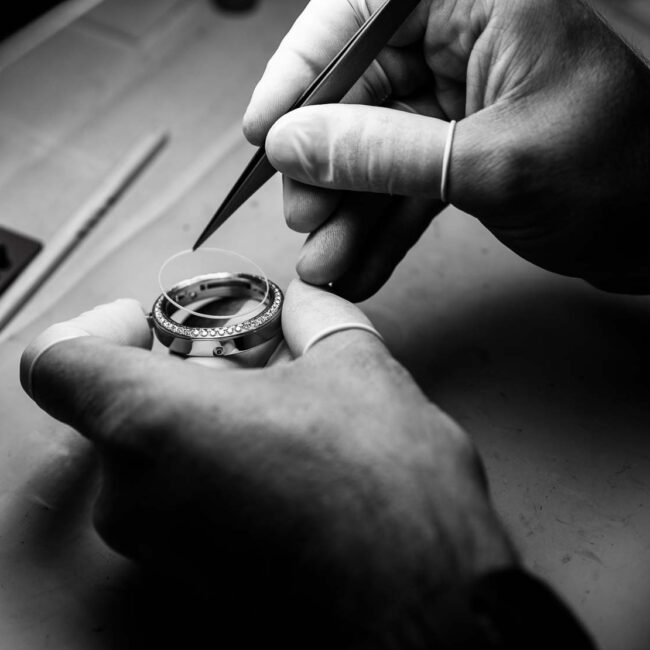 A CNC technician verifies watch case dimensions.