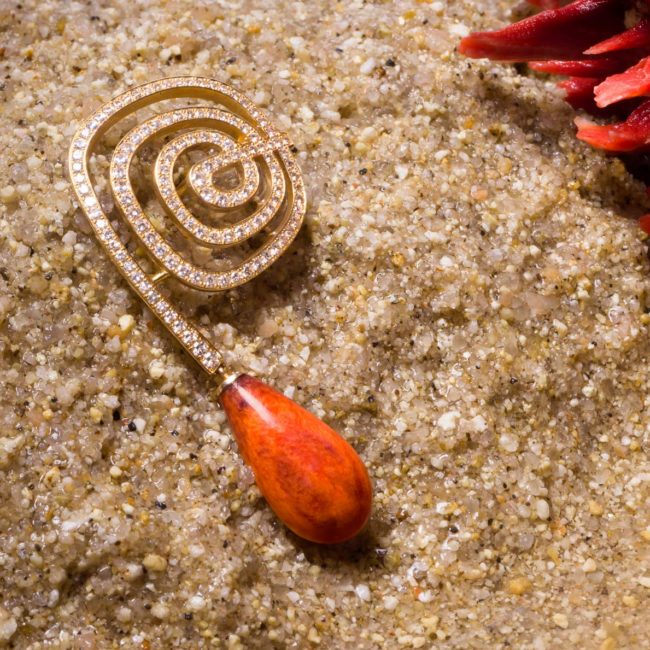 Spondylus oyster shell spiral pendant earrings set with micro-pavé diamonds.